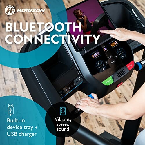 Treadmill console with Bluetooth connectivity, device tray, and stereo sound.