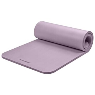 Purple yoga mat partially rolled.