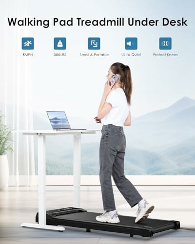 Woman using a walking pad treadmill under a desk while on the phone.