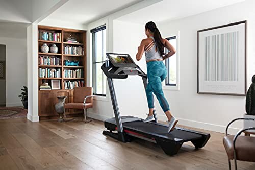 Woman running on a treadmill in a home gym setting