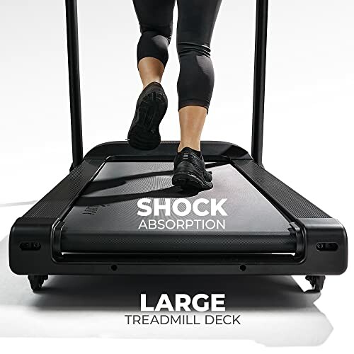 Person running on a treadmill with shock absorption and large deck.